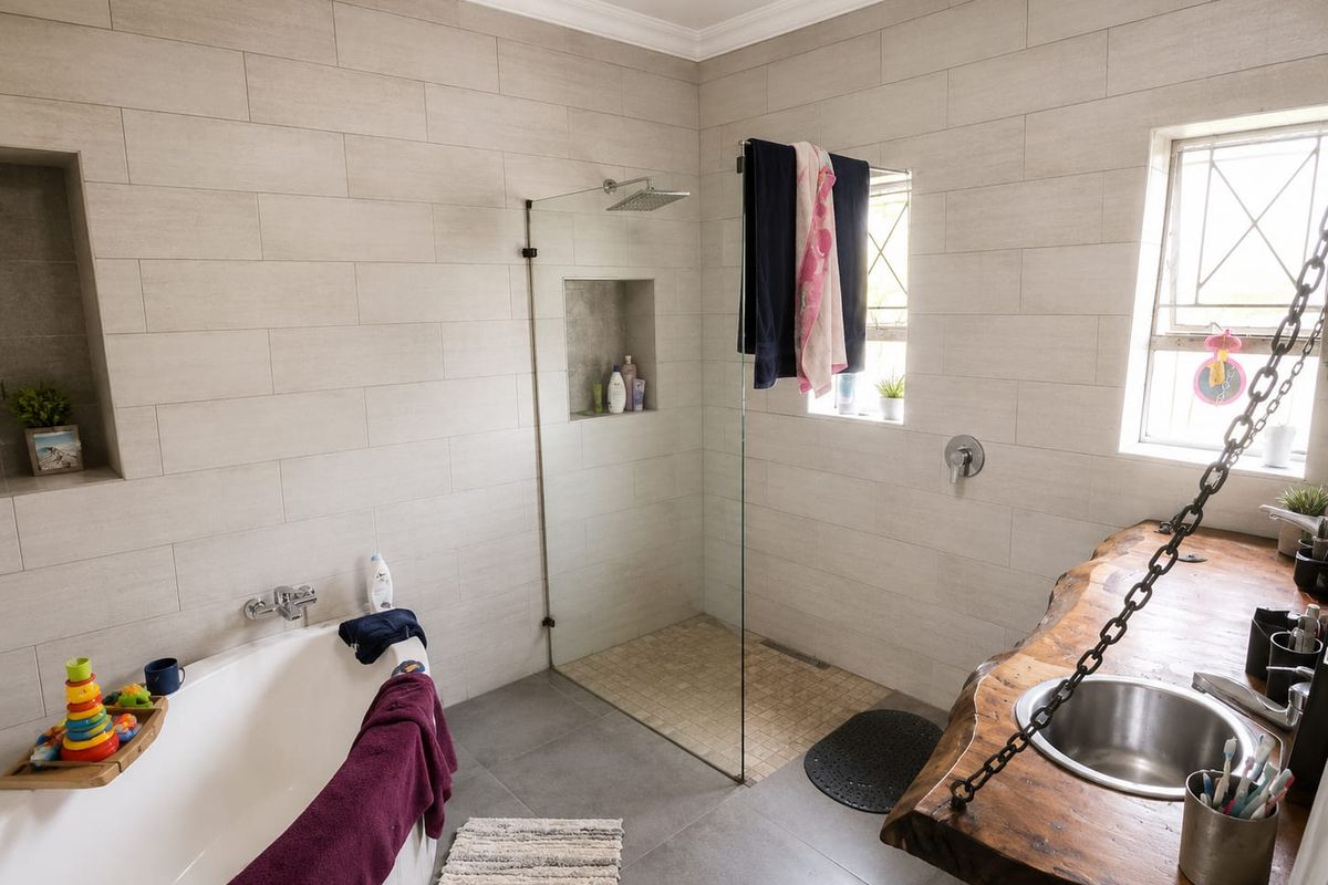Modern bathroom featuring a walk-in shower with glass screen, a freestanding bathtub, and a unique live-edge wood vanity with an undermount sink.