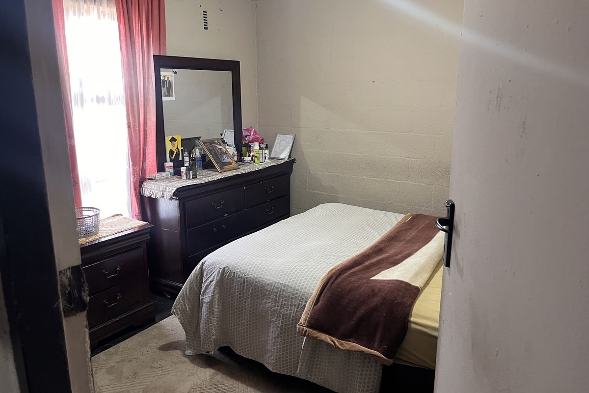 A bedroom featuring painted blockwork walls and coving, requiring cosmetic updates to improve the overall finish and condition of the space.