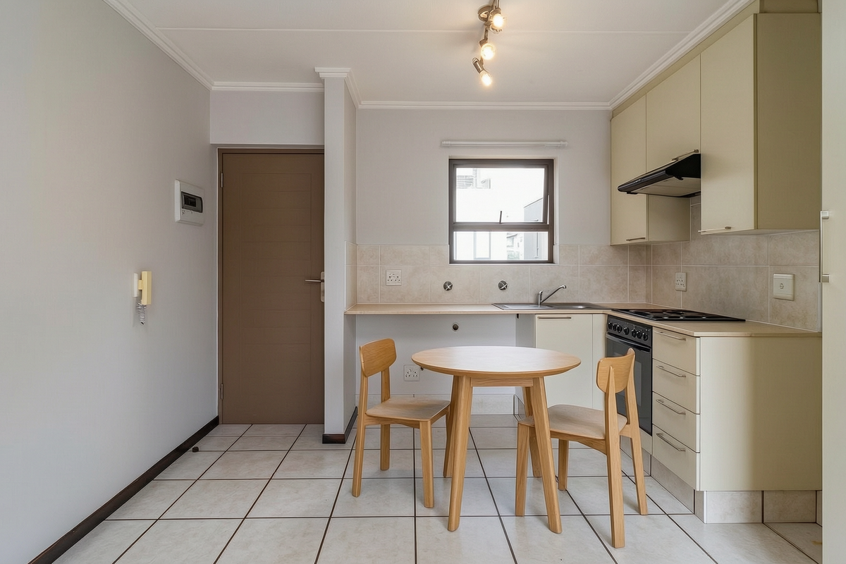 A functional kitchen featuring built-in cabinetry, tiled flooring, a tiled backsplash, and integrated appliances including an oven and hob.
