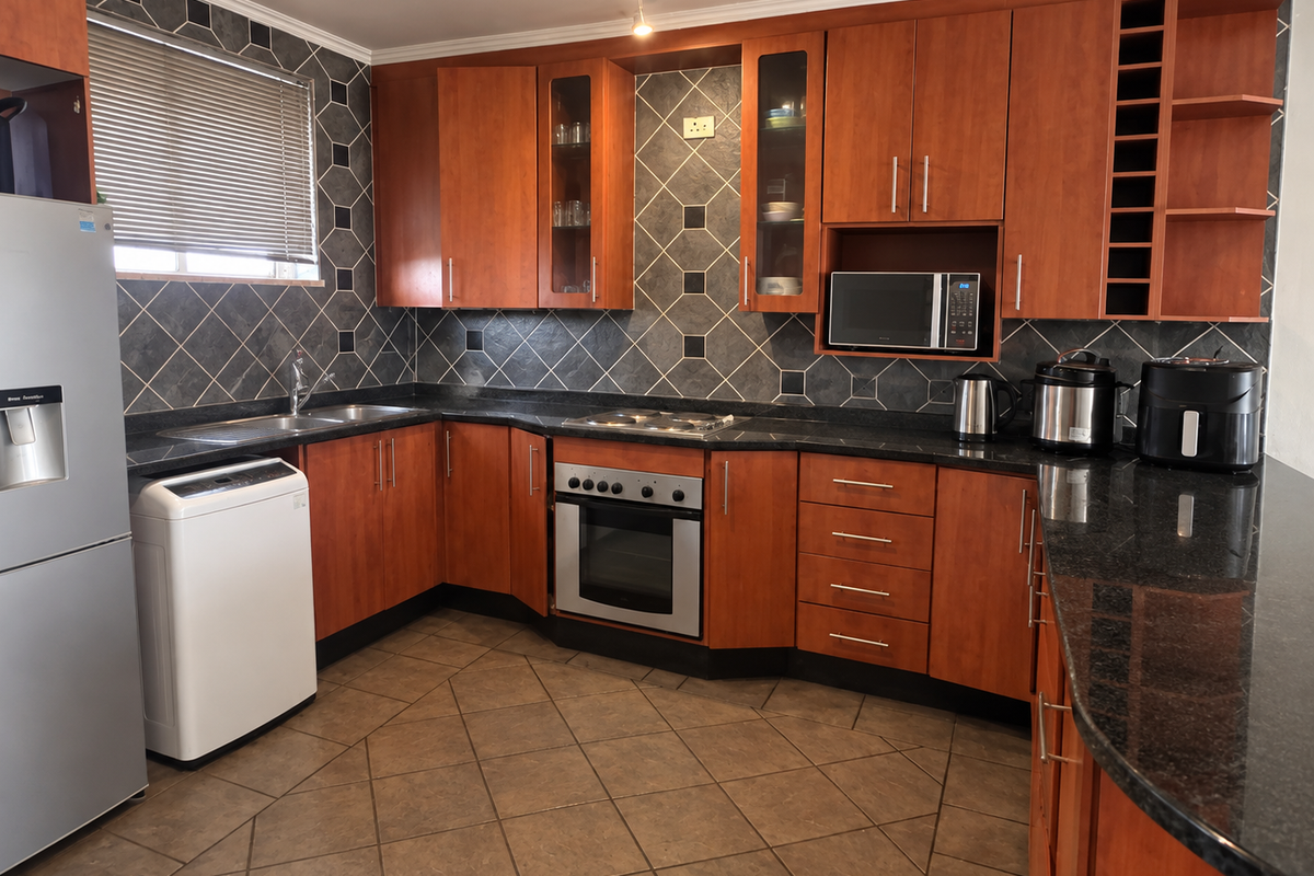 A functional kitchen featuring warm-toned wooden cabinetry, granite countertops, a built-in oven, and a tiled backsplash with a dedicated wine storage rack.