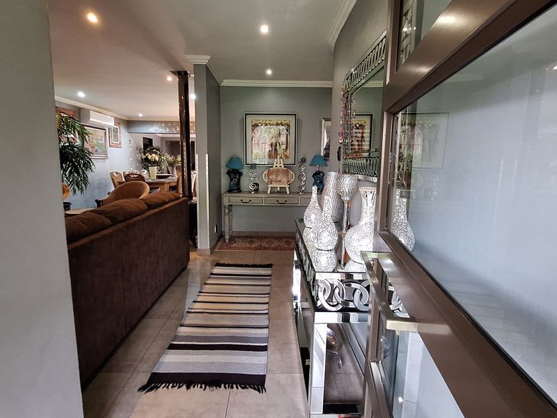 Welcoming entrance hall featuring tiled flooring and recessed downlighting, leading directly into the open-plan living area.