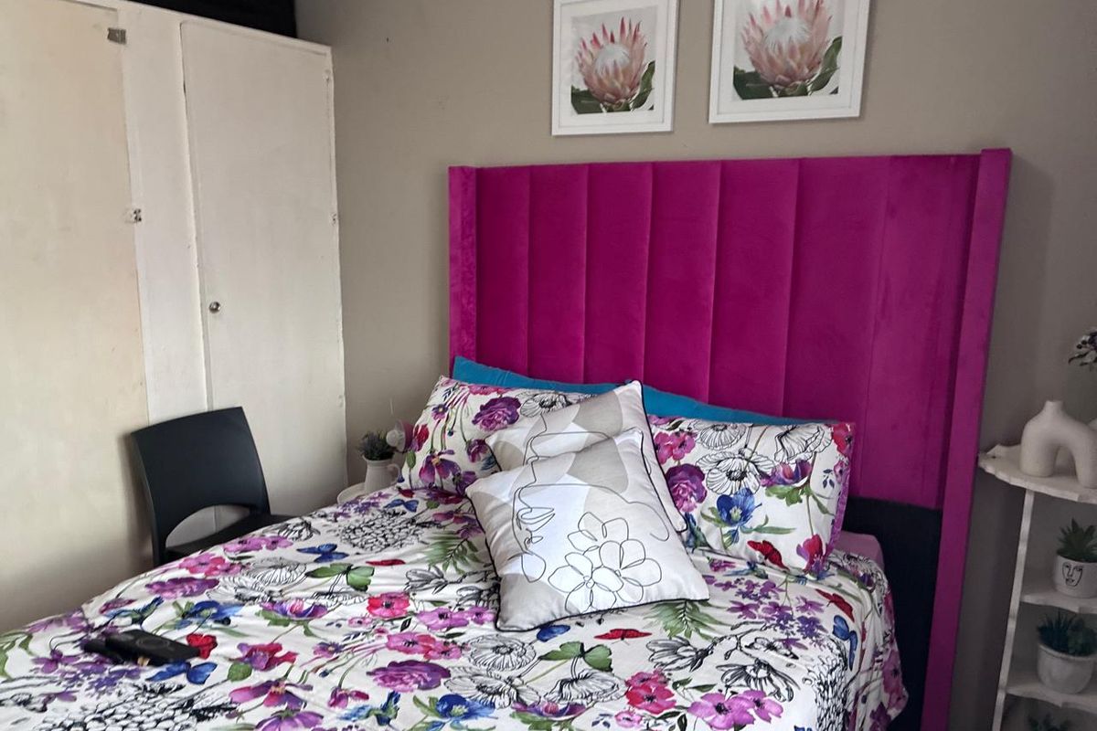 A bedroom featuring a built-in wardrobe and neutral wall finishes, providing a functional space for rest.