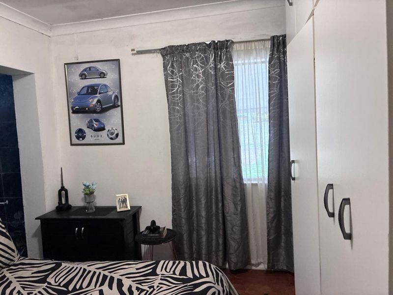 A bedroom featuring built-in wardrobes and coving, providing functional storage space and standard architectural finishes.