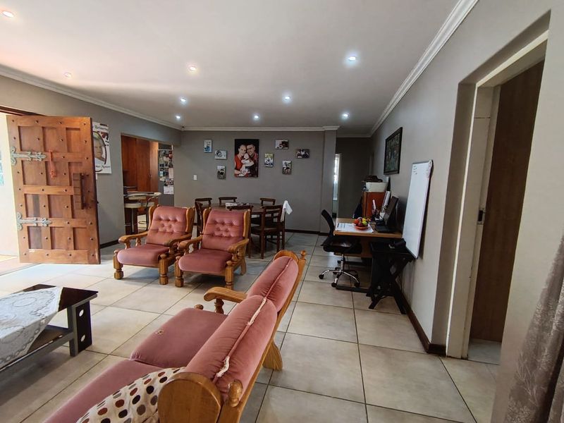 Spacious open-plan living area featuring tiled flooring, recessed downlighting, and coved cornicing, providing a versatile layout for dining and relaxation.