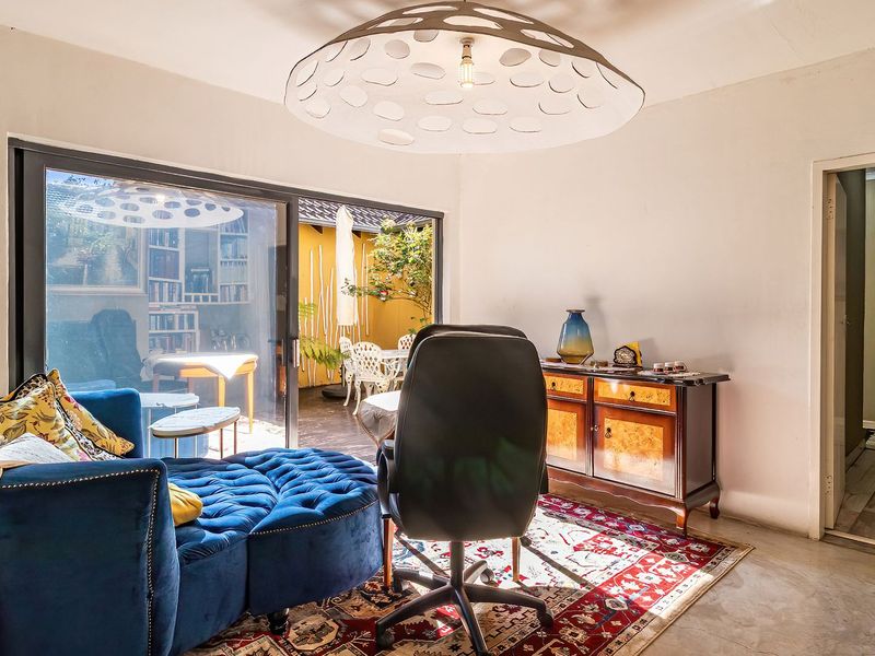 A bright living area featuring polished concrete floors and large sliding glass doors that provide seamless access to the outdoor patio space.