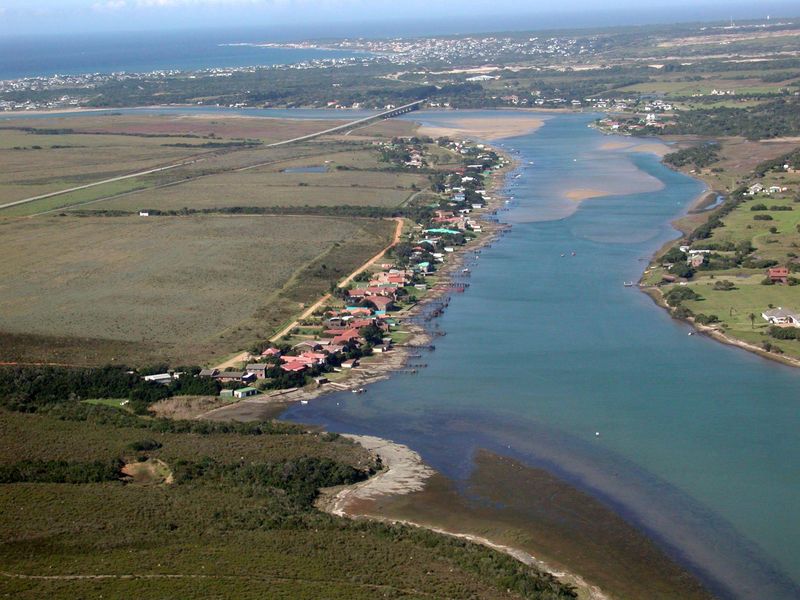An aerial view of the river estuary and surrounding coastal landscape, showcasing the natural environment and proximity to the coastline.