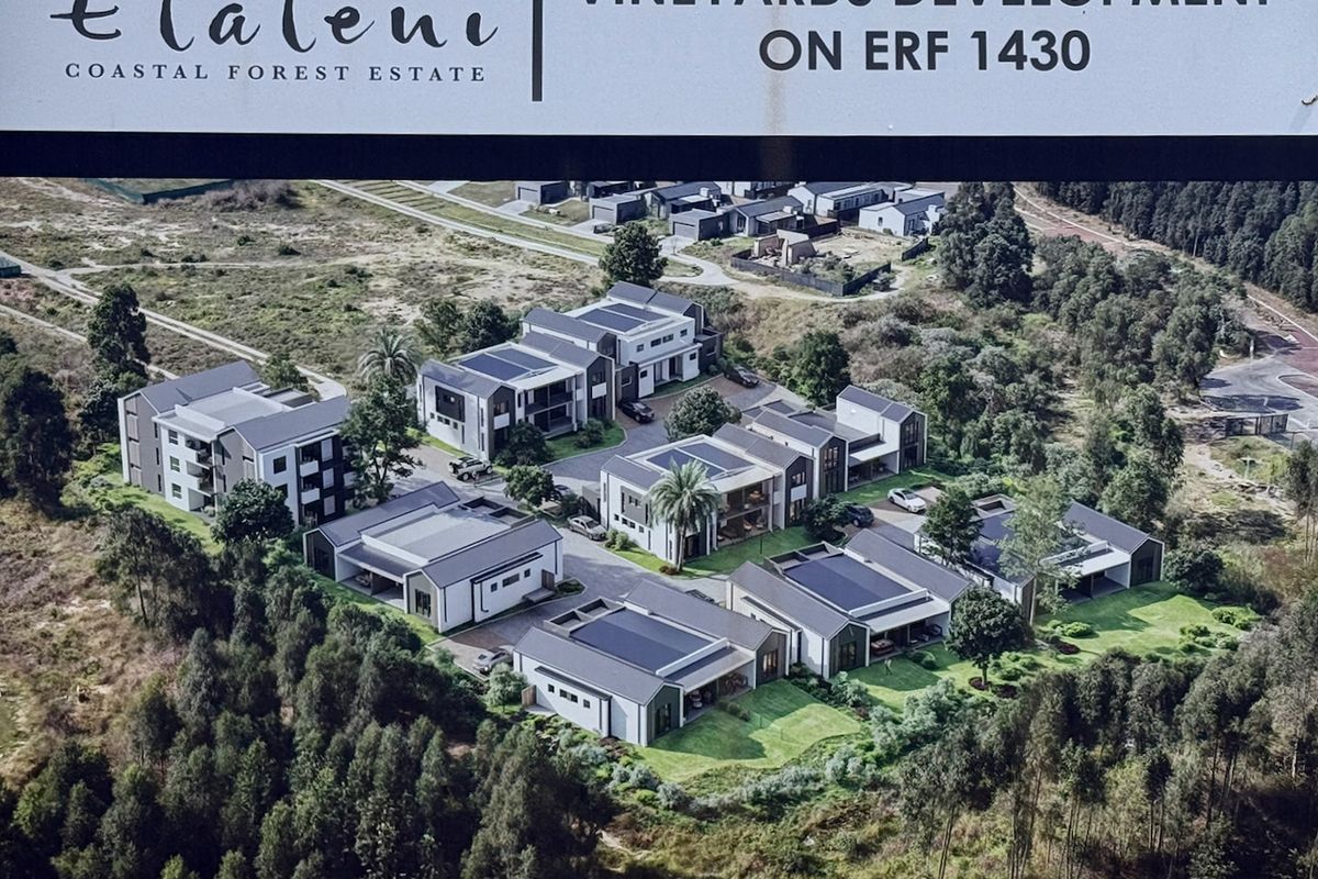 Aerial view of the Elaleni Coastal Forest Estate development, showcasing multiple modern residential units with solar installations and landscaped surroundings.