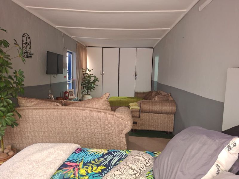 A bedroom featuring built-in cupboards and a simple interior layout with two-tone wall paint.