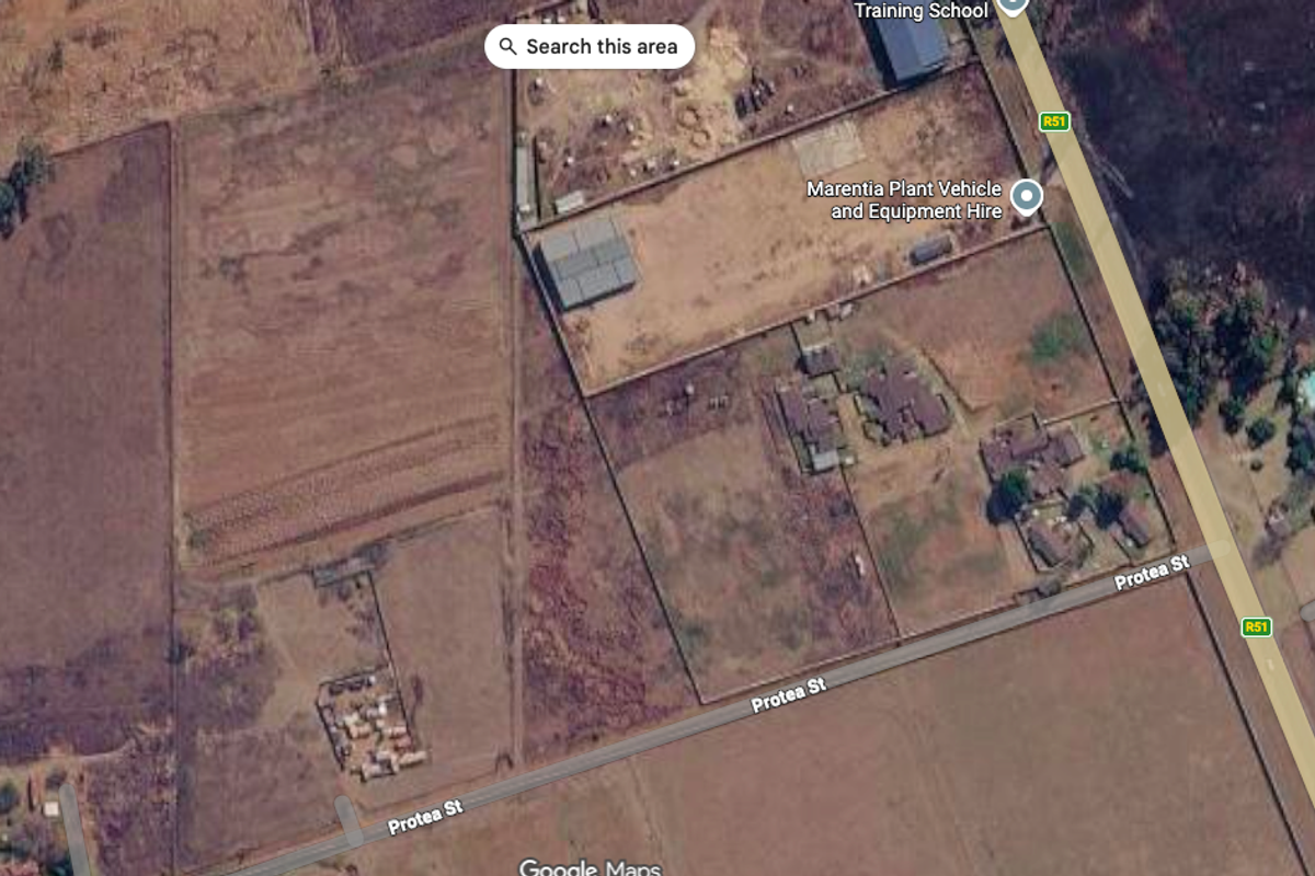 Aerial view of a vacant residential land parcel situated near Protea Street, showing surrounding terrain and existing boundary fencing.