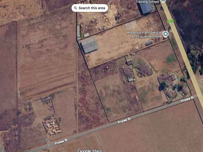 Aerial view of a vacant residential land parcel situated near Protea Street, showing surrounding terrain and existing boundary fencing.