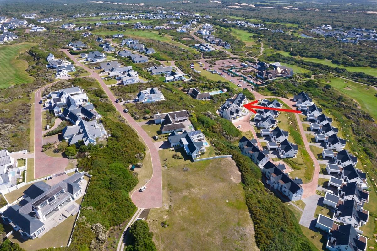 An aerial view of a residential estate showing the property location within the development, surrounded by landscaped grounds and paved access roads.