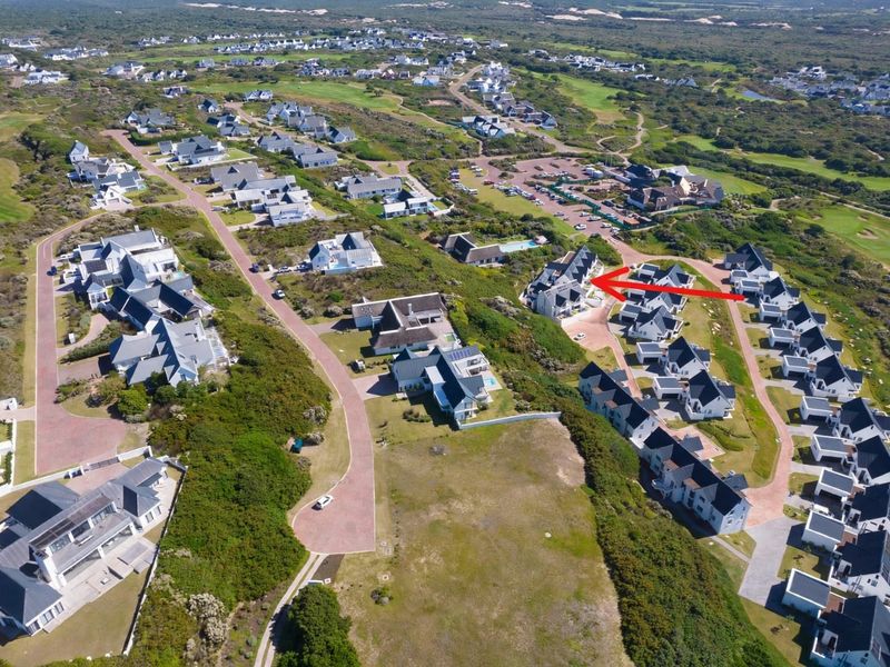 An aerial view of a residential estate showing the property location within the development, surrounded by landscaped grounds and paved access roads.