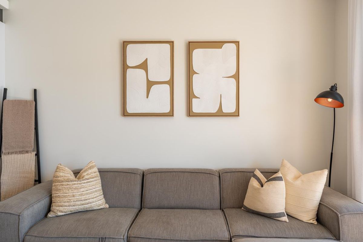 A well-maintained living room area featuring neutral wall tones and a clean, modern aesthetic.