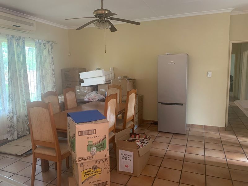 Dining area featuring tiled flooring, a ceiling fan, and an integrated air conditioning unit.