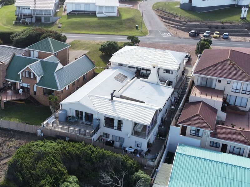 Aerial view of the property showing the roof structure, solar panels, and surrounding residential neighborhood context.