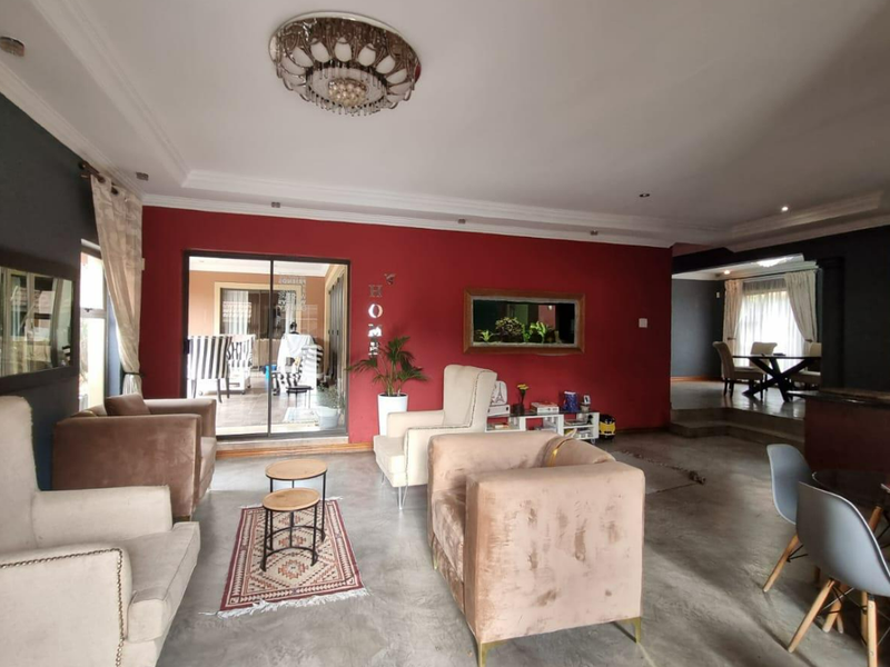 Spacious open-plan living area featuring polished concrete floors, coved ceilings, and large sliding glass doors providing seamless access to the outdoor patio space.