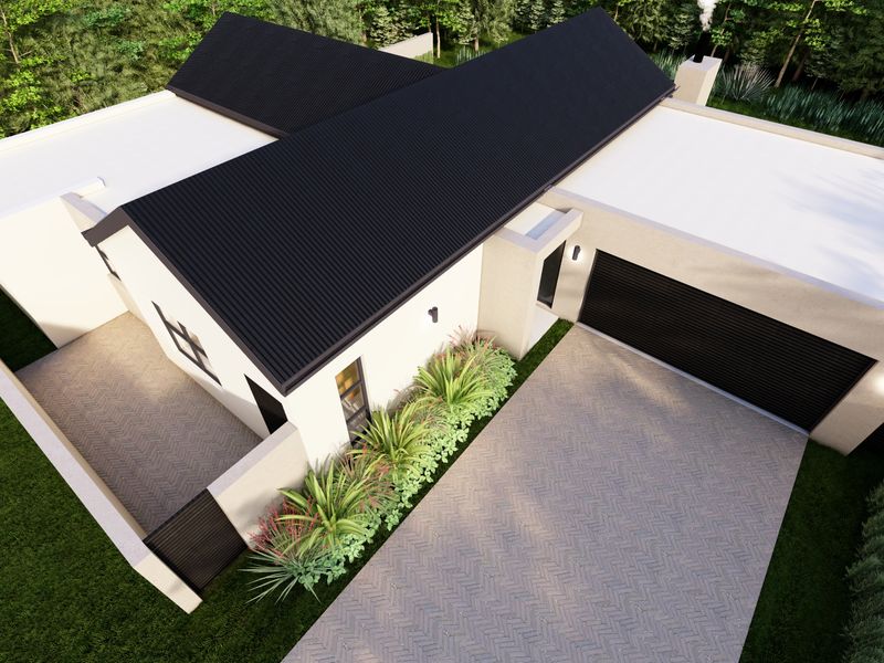 Aerial view of a modern residential property featuring a corrugated metal roof, double garage, and a paved herringbone driveway.