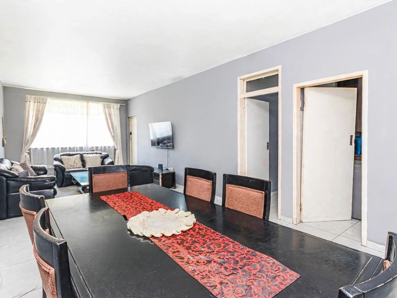 Open plan living and dining area featuring tiled flooring and neutral wall finishes, providing a functional space for daily living.