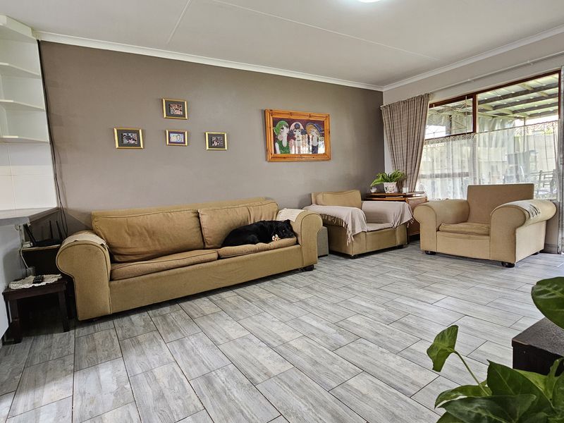 Open plan living area featuring tiled flooring and direct access to an outdoor patio through a sliding glass door.