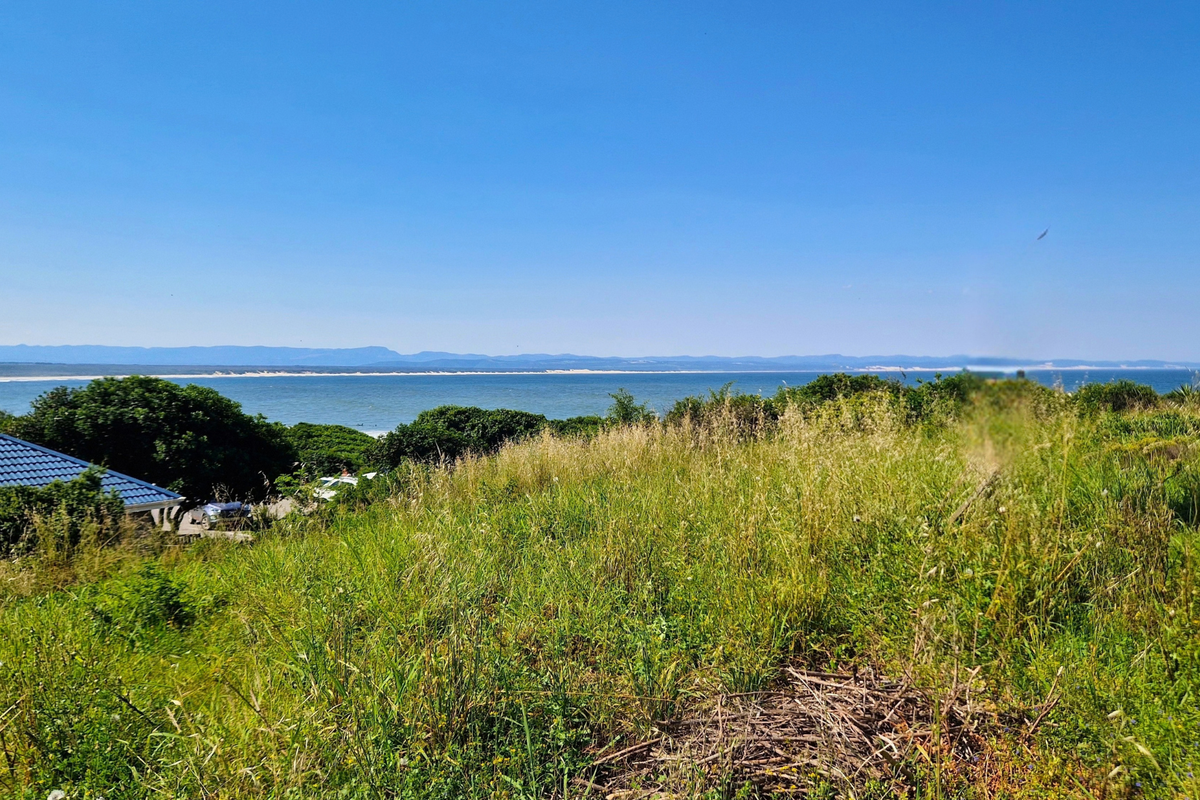 A scenic view overlooking the coastline and ocean from the elevated vacant residential land.