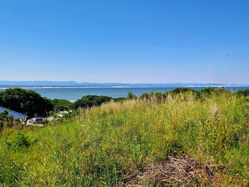 A scenic view overlooking the coastline and ocean from the elevated vacant residential land.