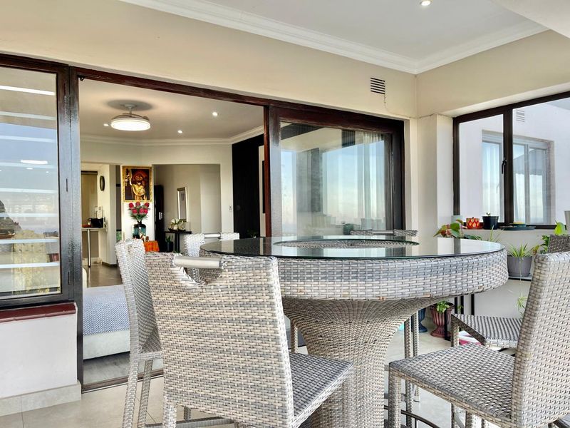 A covered balcony featuring tiled flooring and large sliding glass doors that provide seamless access to the interior living space.
