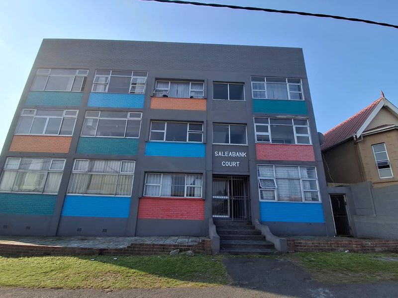 Front elevation of Saleabank Court apartment building featuring a multi-colored brick facade, aluminum windows, and a secure entrance with concrete steps.