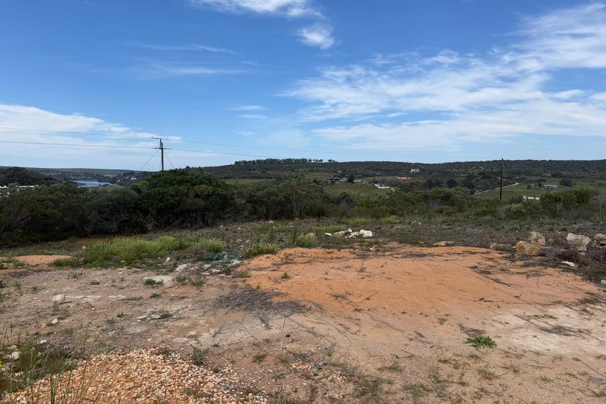 A scenic view overlooking the vacant residential land with natural vegetation and distant landscape vistas.
