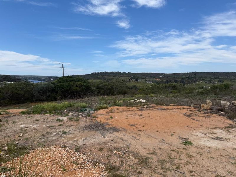 A scenic view overlooking the vacant residential land with natural vegetation and distant landscape vistas.
