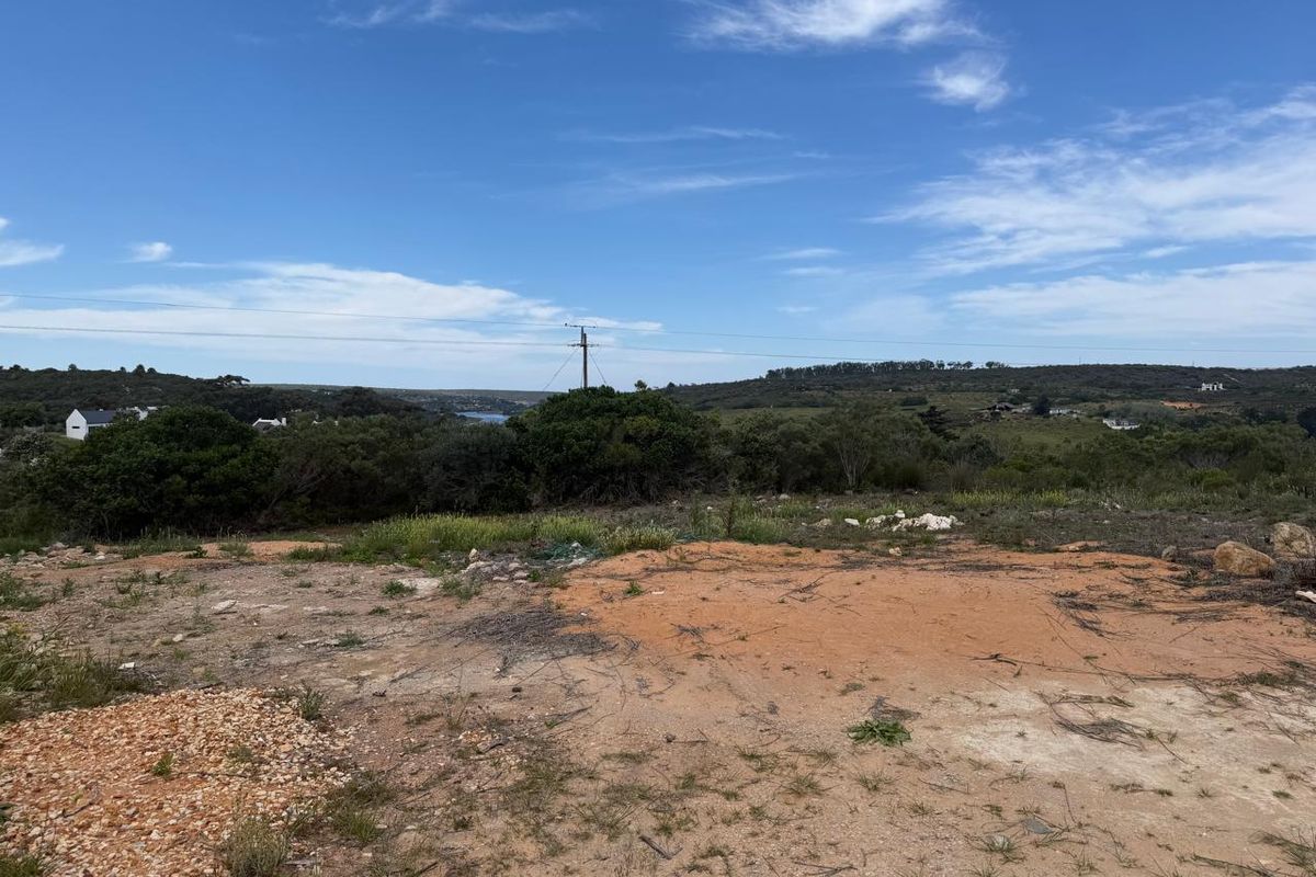 A view of the surrounding landscape and natural terrain from the vacant residential plot.