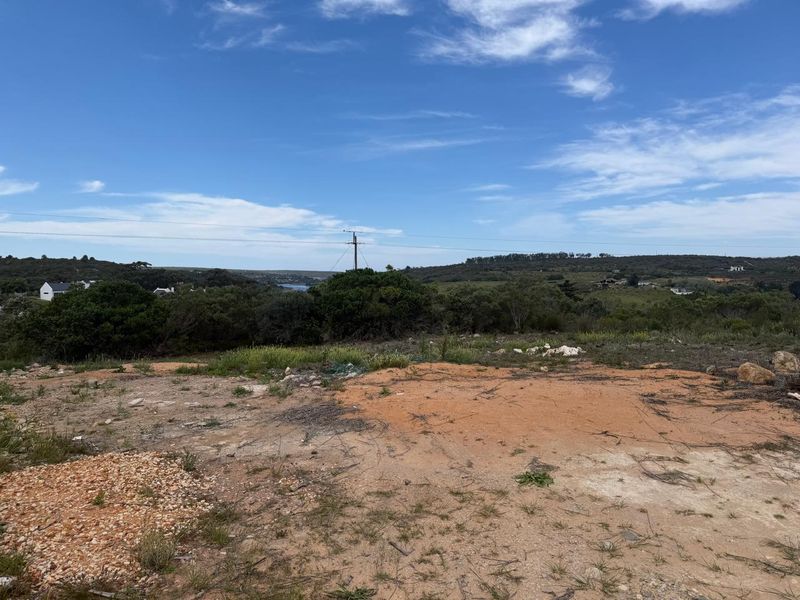 A view of the surrounding landscape and natural terrain from the vacant residential plot.