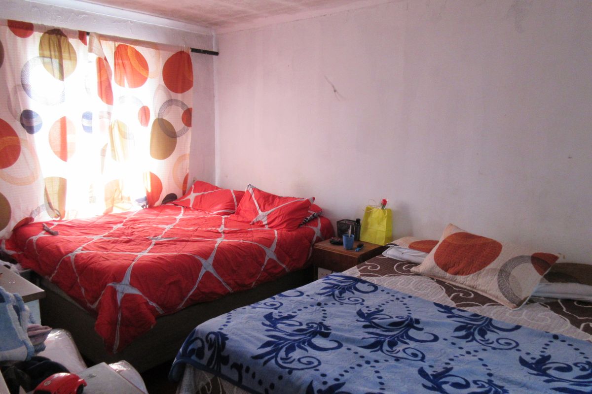 A bedroom space featuring visible wear on the ceiling and walls, requiring cosmetic updates to improve the overall condition and appeal.