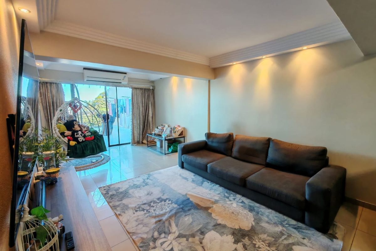 A well-lit living room featuring tiled flooring, recessed ceiling lighting, crown molding, and a split-system air conditioner with access to an adjoining balcony.