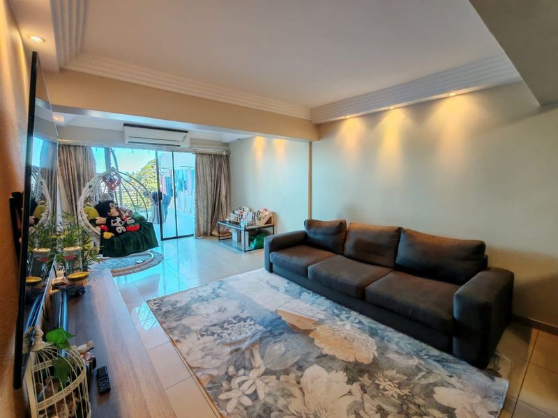 A well-lit living room featuring tiled flooring, recessed ceiling lighting, crown molding, and a split-system air conditioner with access to an adjoining balcony.