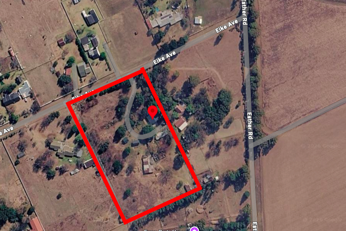 Aerial view of the small holding property showing the plot boundaries, existing structures, and driveway access from Eike Avenue.