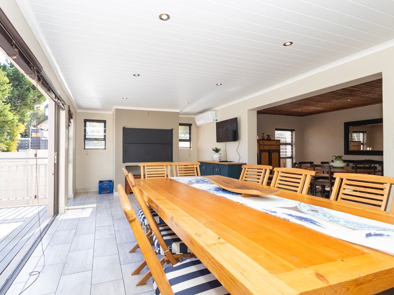 Spacious covered patio featuring tiled flooring, recessed lighting, and large sliding glass doors that provide seamless access to the outdoor area.