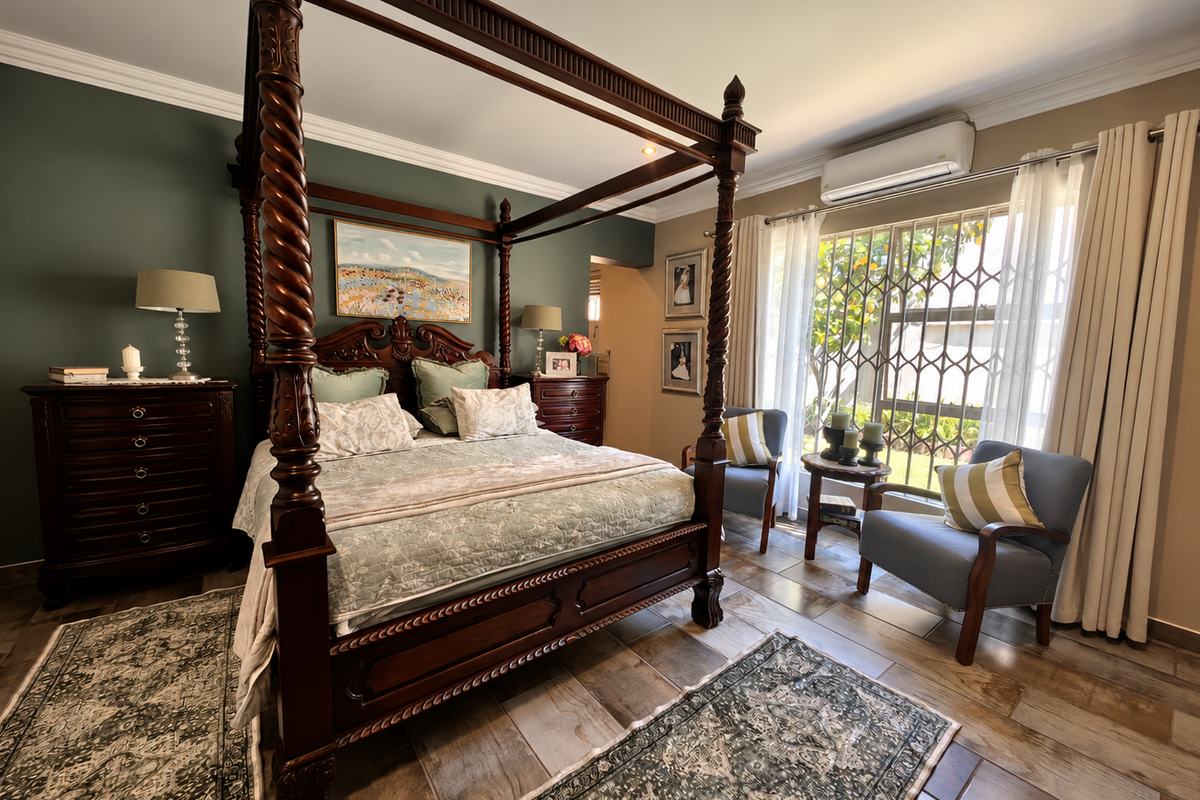 A well-maintained bedroom featuring tiled flooring, crown molding, recessed lighting, and a wall-mounted split-system air conditioner with security gate access to the exterior.