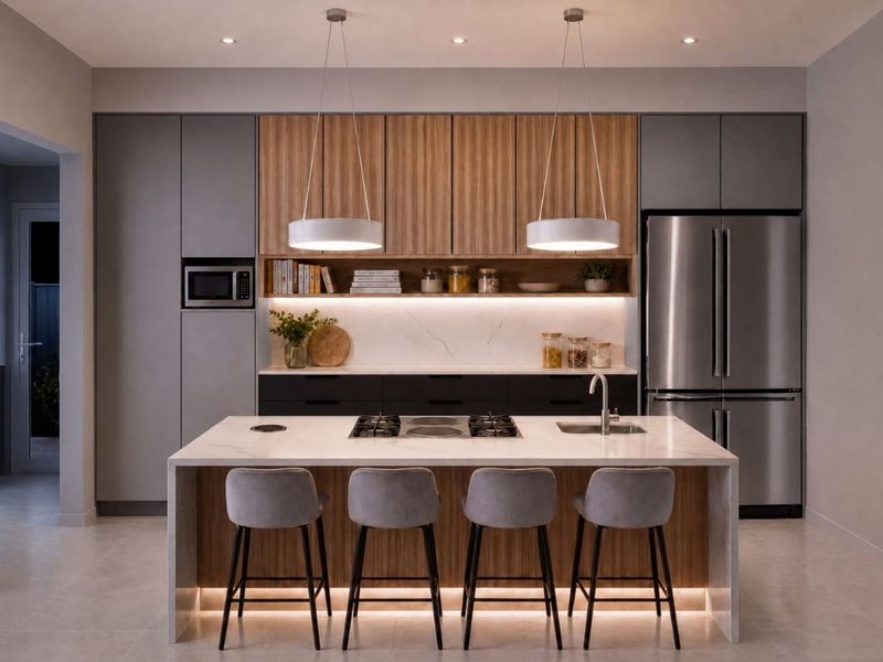 Modern kitchen featuring a central island with stone benchtop, integrated appliances, sleek cabinetry, and sophisticated pendant and under-cabinet lighting.
