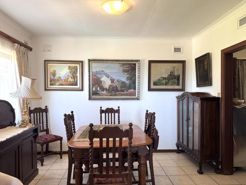 A traditional dining room featuring tiled flooring, coved ceilings, and integrated air conditioning vents, providing a functional space for family meals.