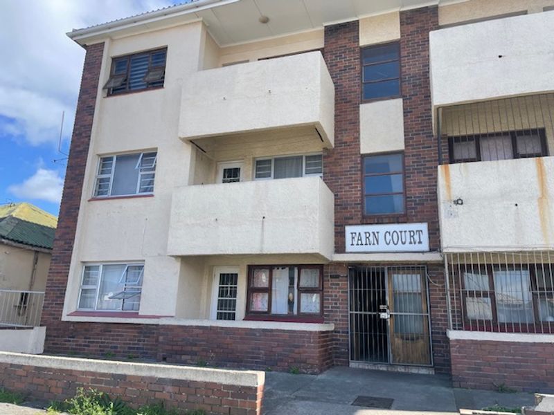 Front elevation of Farn Court apartment building featuring brick and plaster facade, private balconies, and secure ground floor entrance.