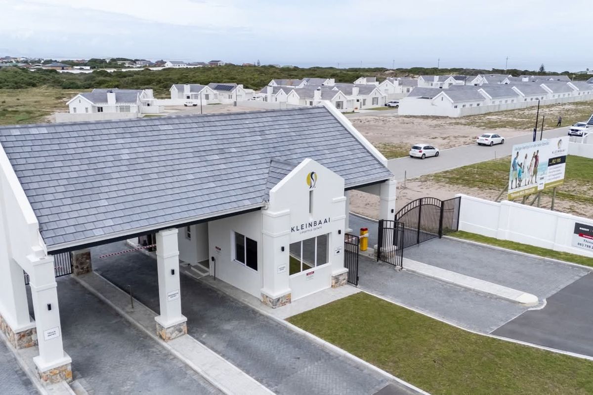 Aerial view of the Kleinbaai Lifestyle Estate security entrance gatehouse featuring paved access lanes and perimeter fencing.