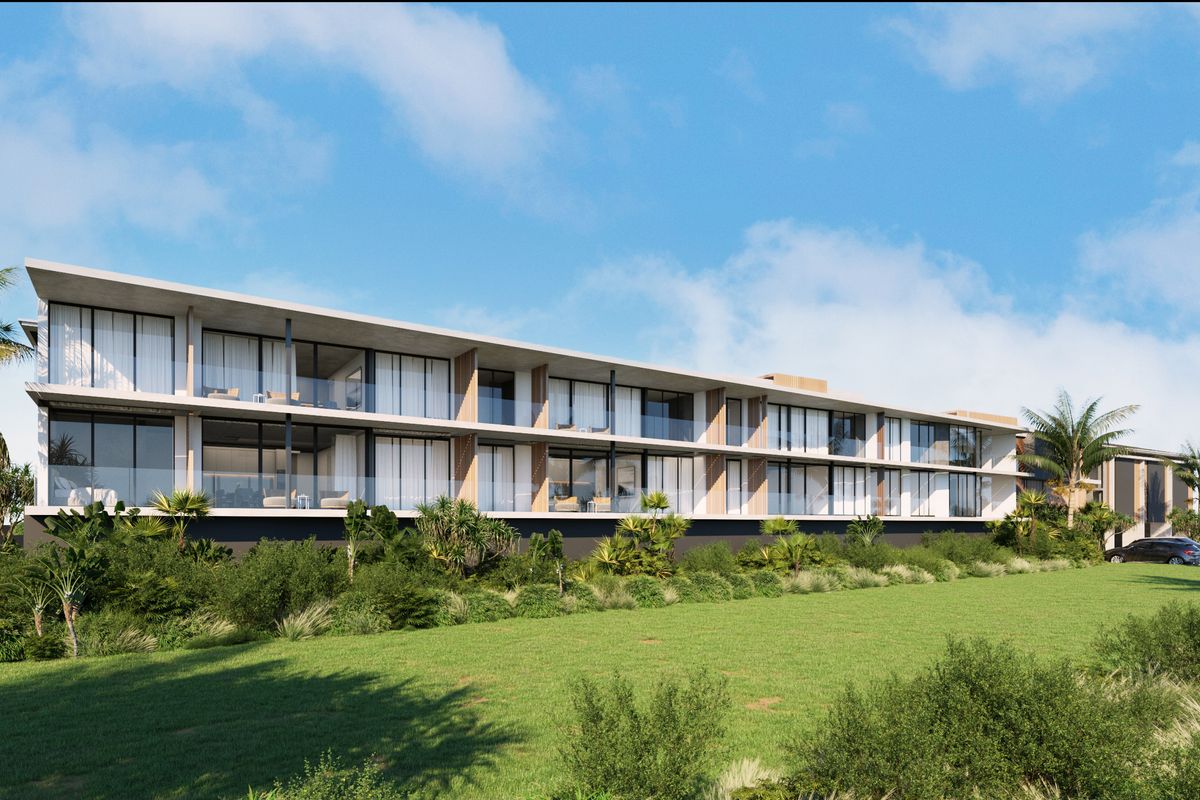 A modern multi-story apartment building featuring expansive glass balconies, clean architectural lines, and lush landscaped grounds.