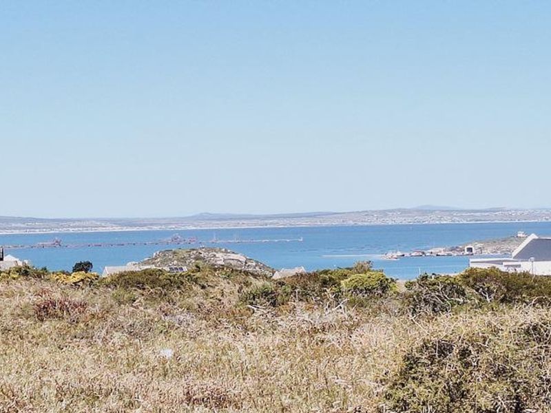 A scenic view overlooking the coastal landscape and ocean, showcasing the natural surroundings of the vacant residential land.