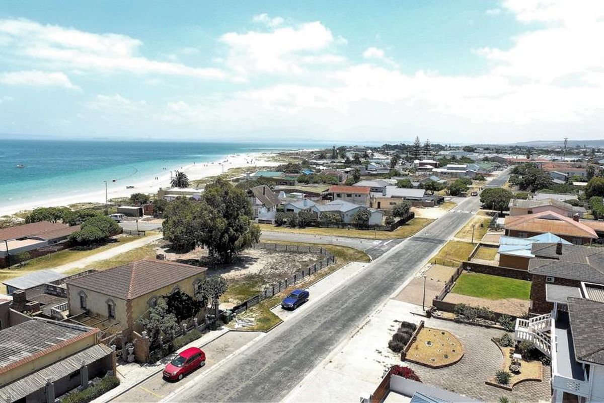 An aerial view of a coastal residential neighborhood showing proximity to the beach and local street infrastructure.