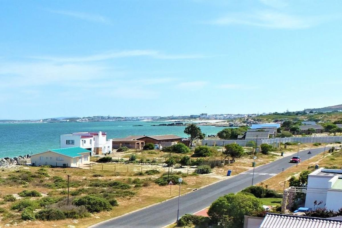 A scenic elevated view of the coastal residential area, featuring proximity to the ocean, local roads, and surrounding neighborhood landscape.