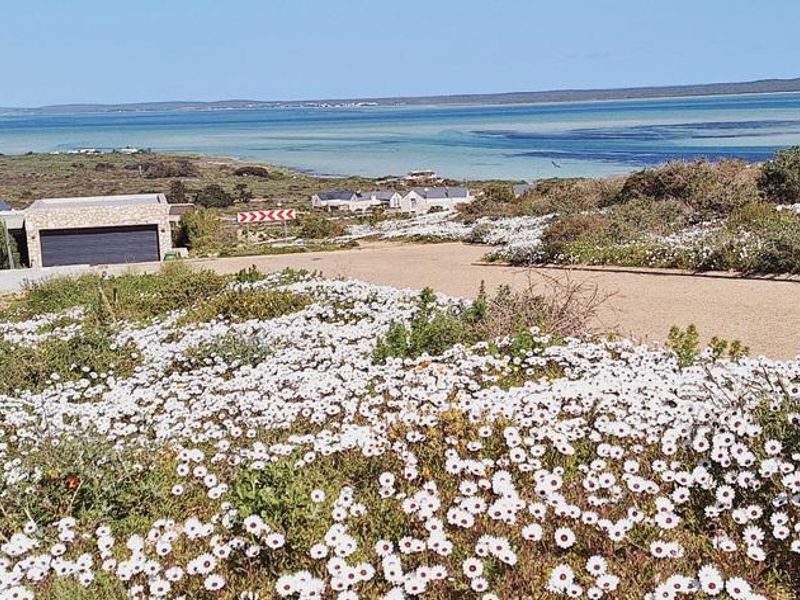 A scenic view of the coastal landscape and lagoon, showcasing the natural beauty and surroundings of the vacant residential land.