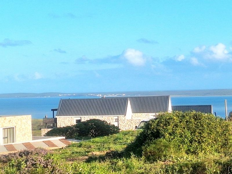A scenic view overlooking the coastal landscape and ocean, showcasing the surrounding residential area and natural environment.