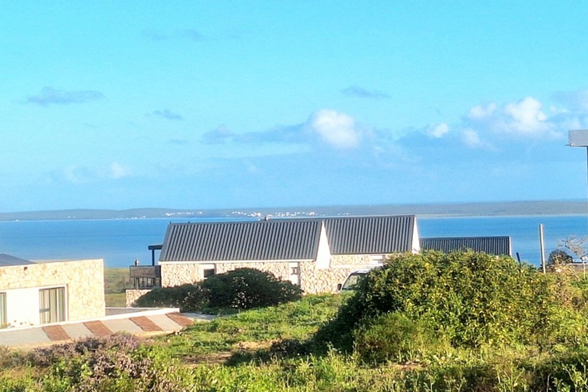 A scenic view overlooking the coastal landscape and ocean, showcasing the surrounding residential area and natural environment.