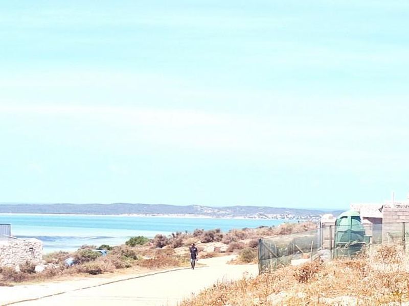 A scenic view of the coastal landscape and water, showcasing the natural surroundings of the residential land.