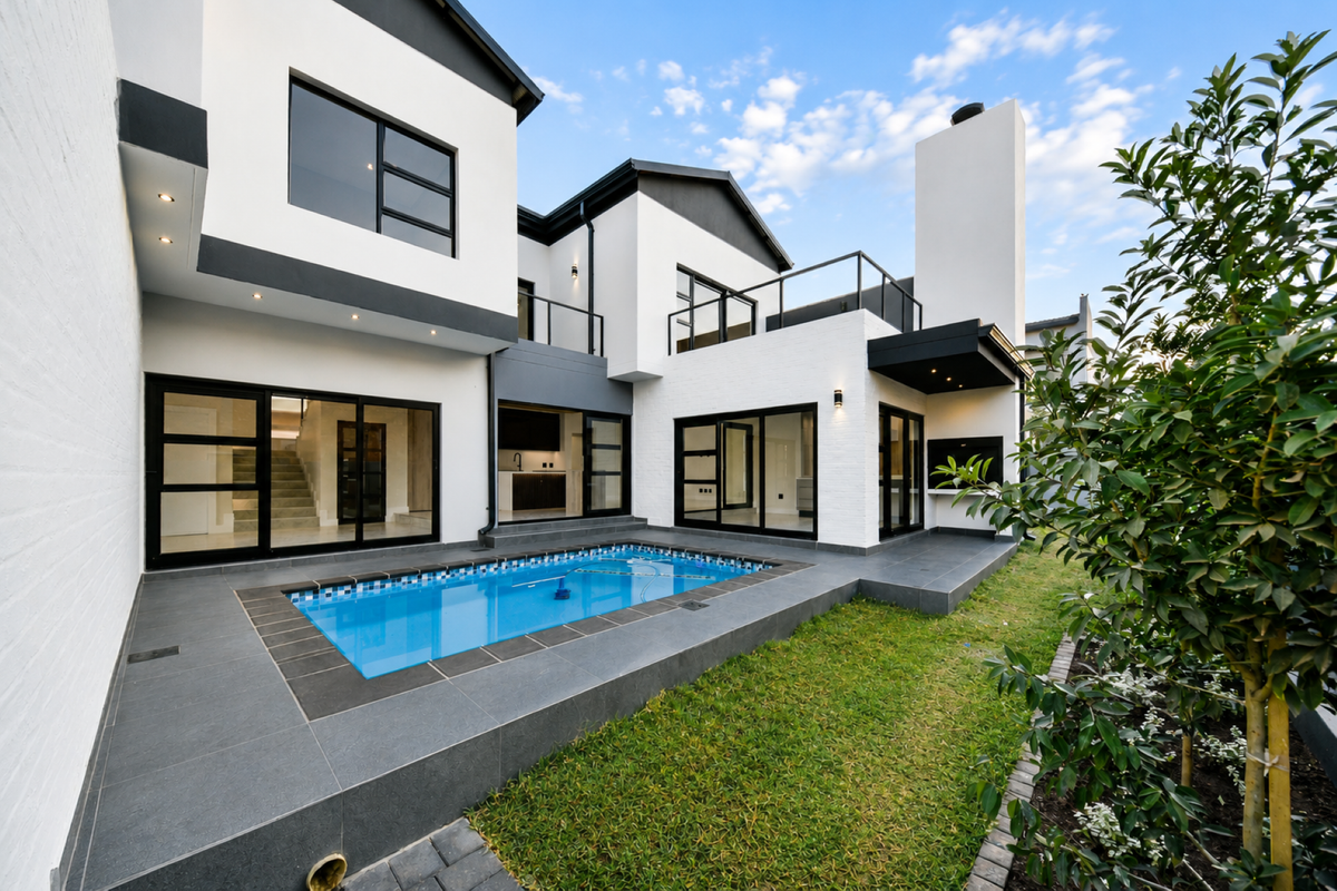 Modern rear exterior featuring a swimming pool, tiled patio, built-in braai, and contemporary architectural design with large glass sliding doors.